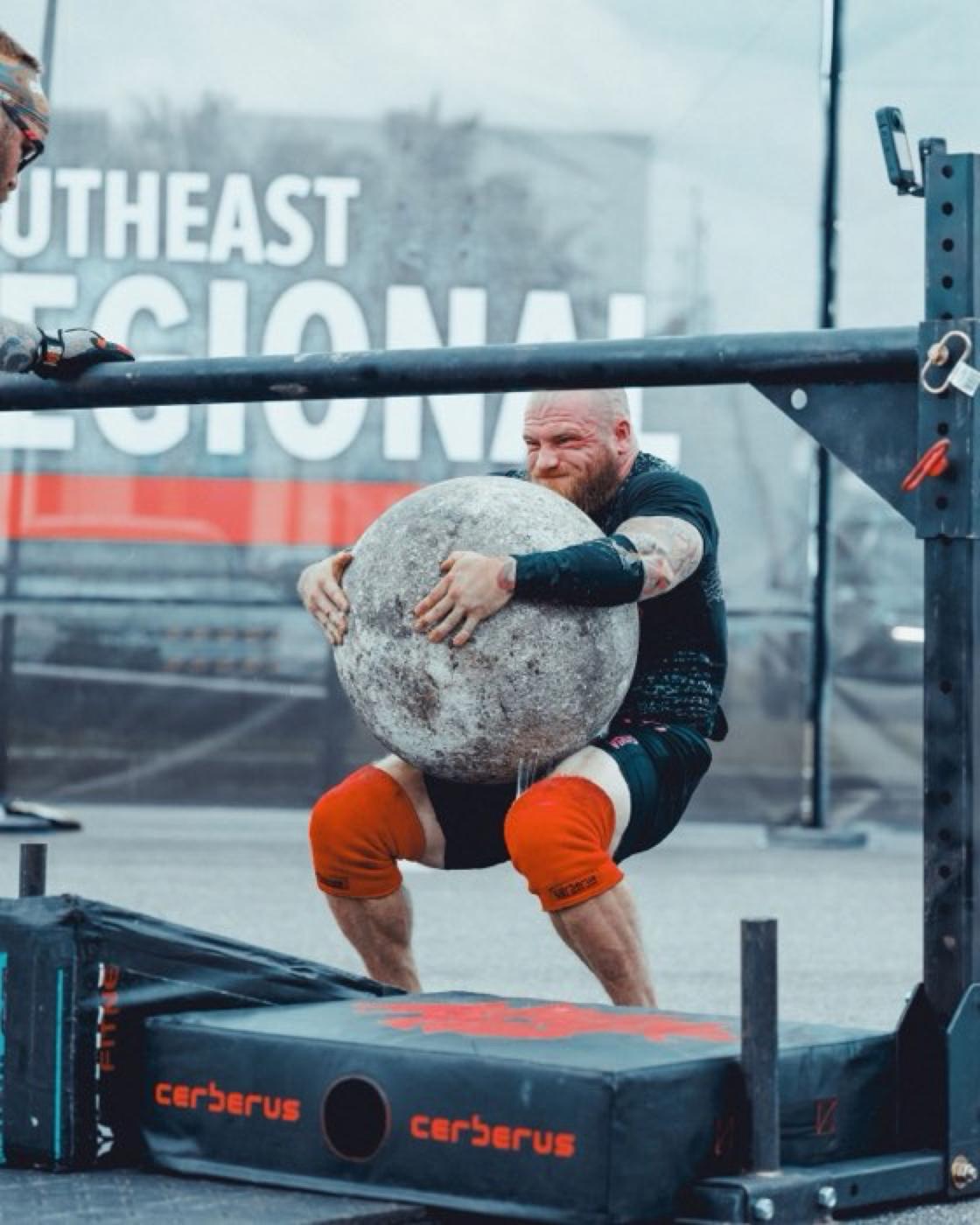 Strongman lifting an atlas stone